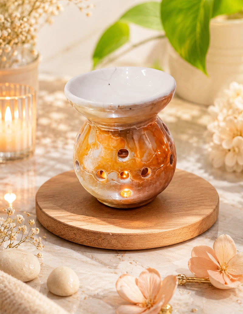 Amber and cream marbled ceramic tealight oil diffuser glowing